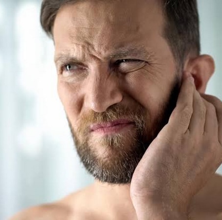 man holding ear