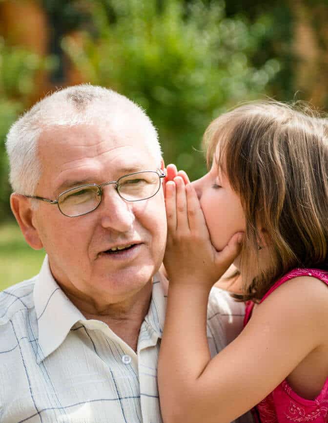grandfather listening to granddaughter whispering