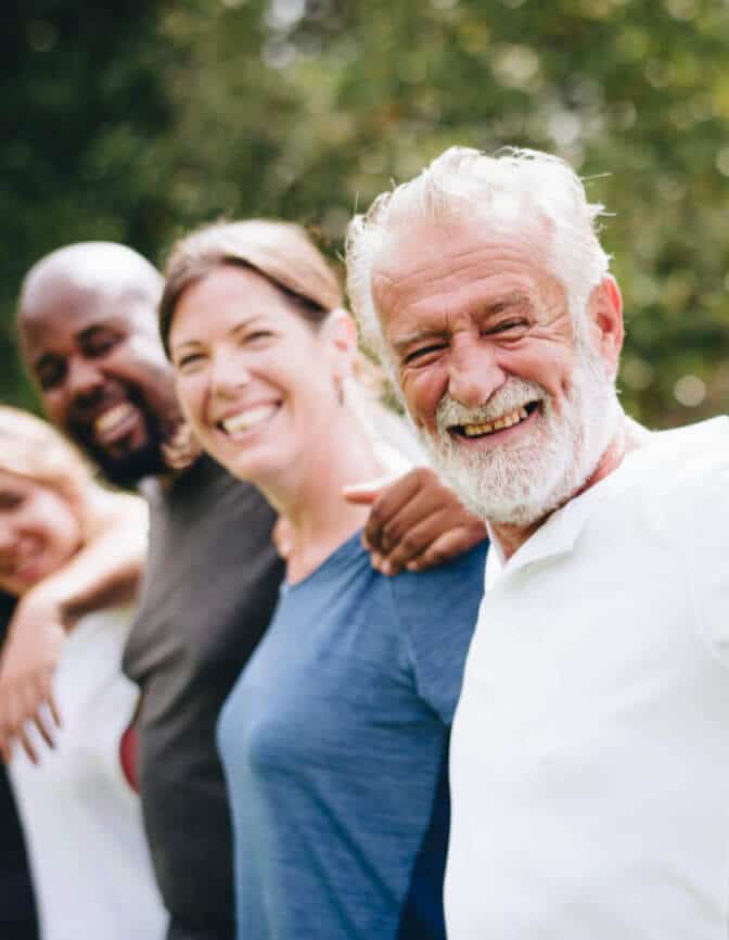 older man has good cognitive health with friends group at park