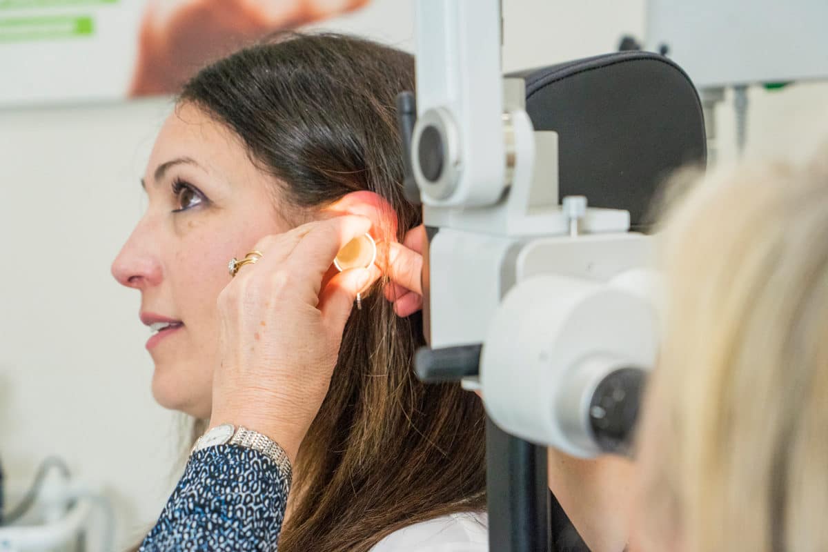 Victorian Hearing audiologist examining ear