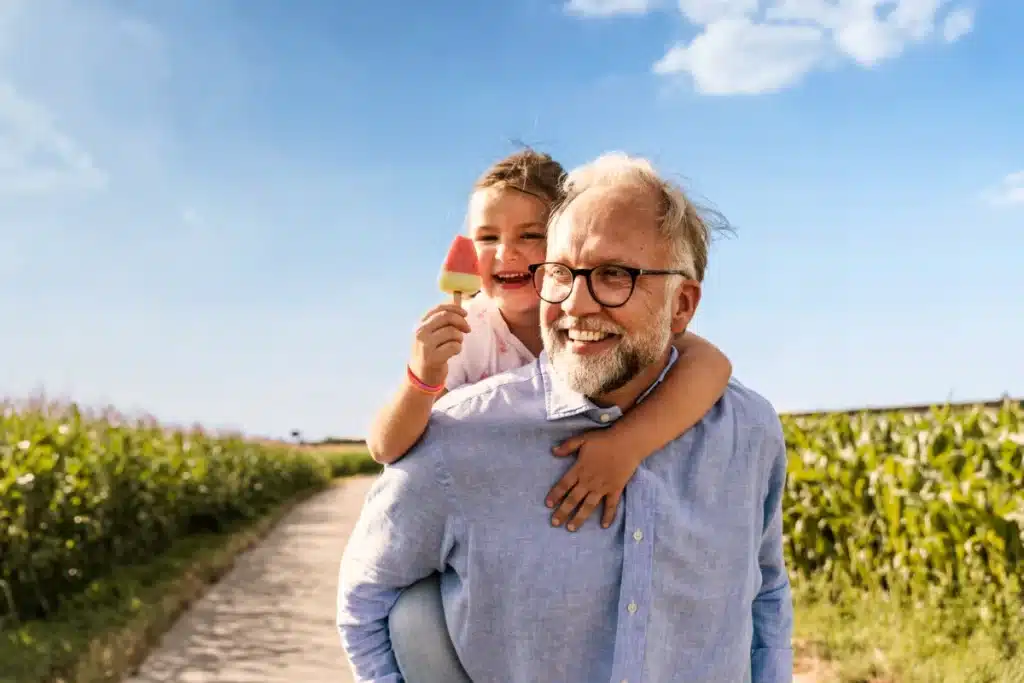 Hearing aid technology grandfather and grandchld with Popsicle