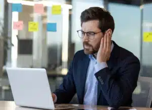 Man with sore ear- get Professional Ear Wax Removal Near You